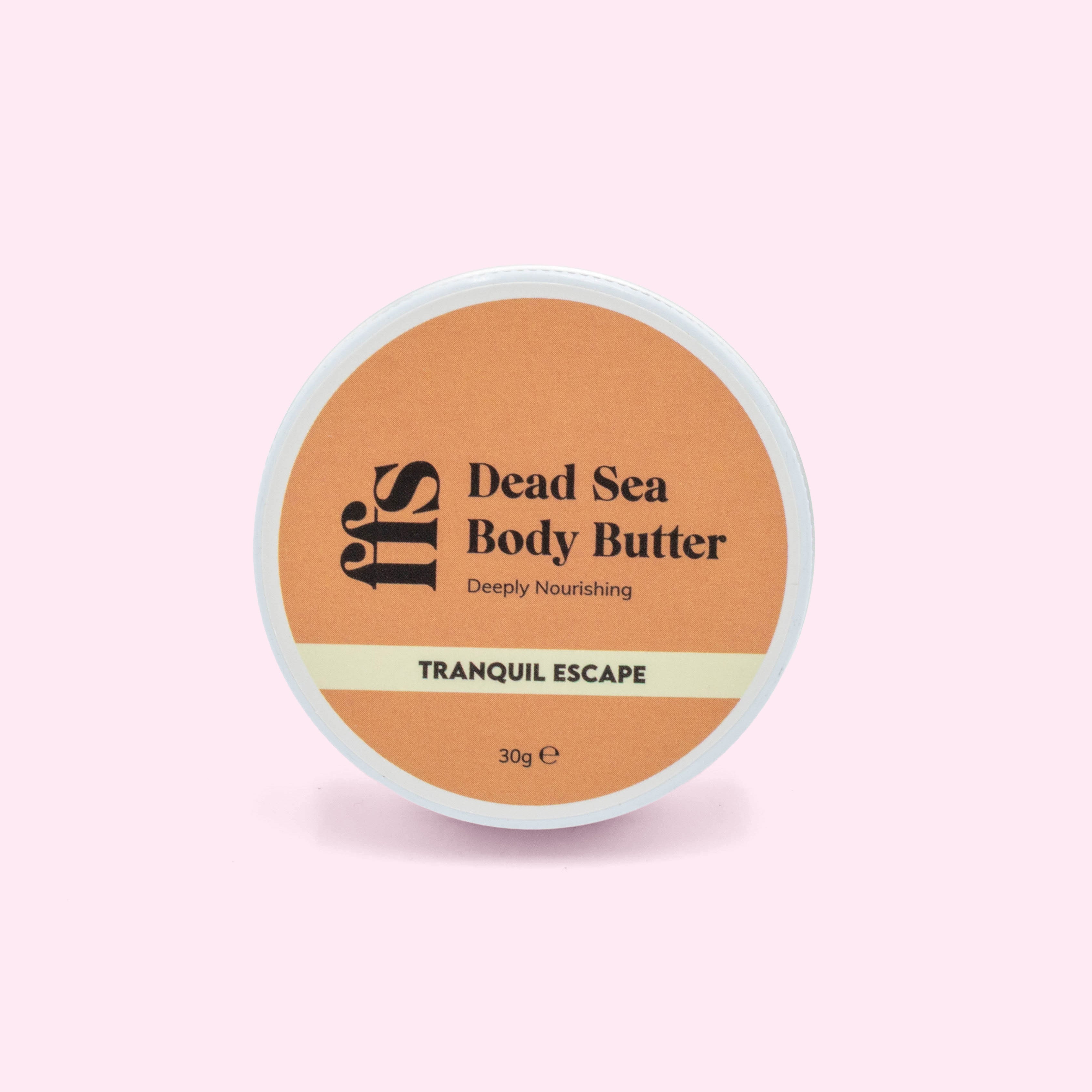 FFS Dead Sea Body Butter in Tranquil Escape, 30g travel size tub viewed from above showing the amber lid label